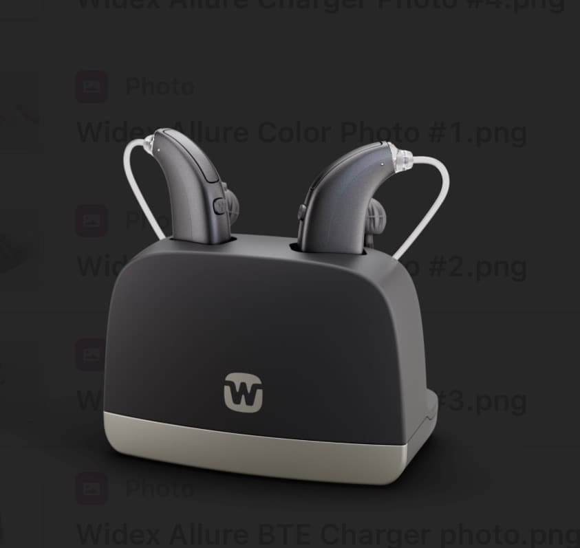 Two grey hearing aids charging in a black and silver Widex brand charging base.
